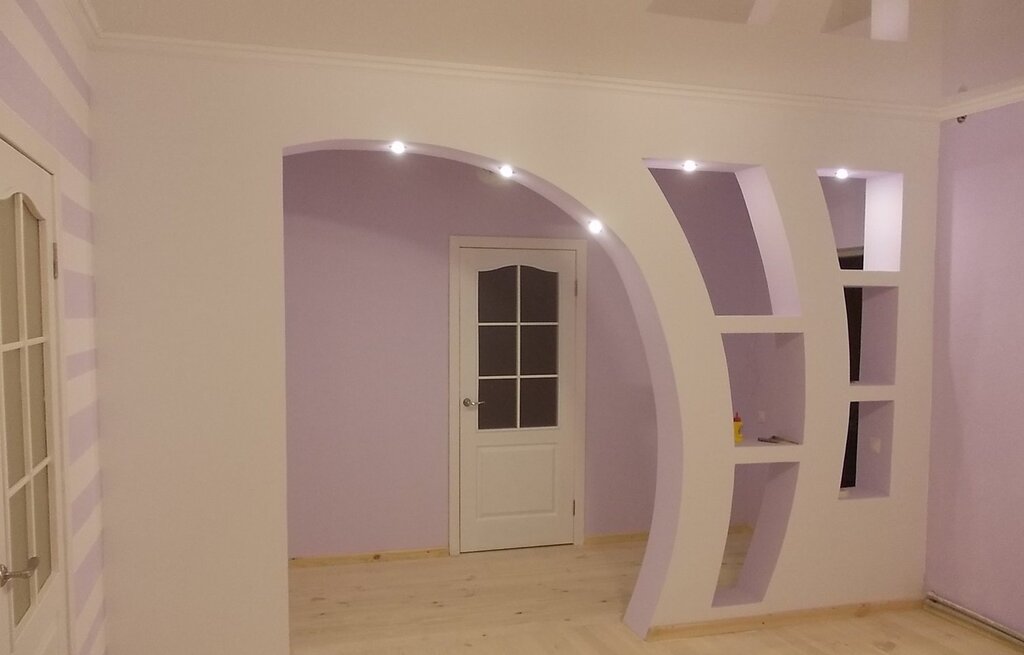 An interior arch made of drywall with shelves