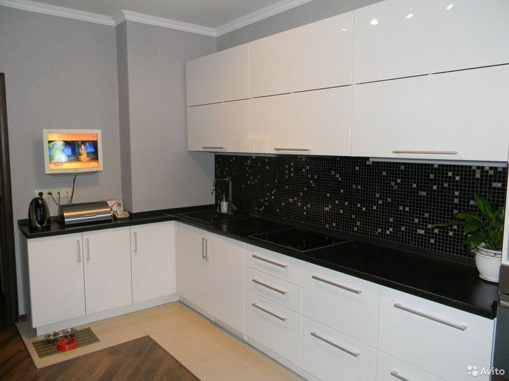 White kitchen with a black backsplash