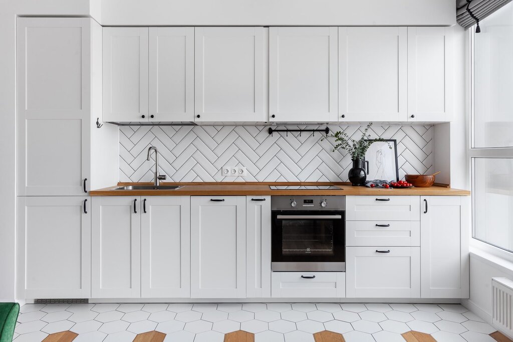 White matte kitchen with a wooden countertop