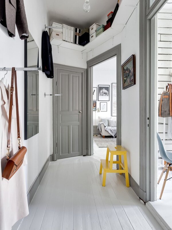 A white hallway with black handles