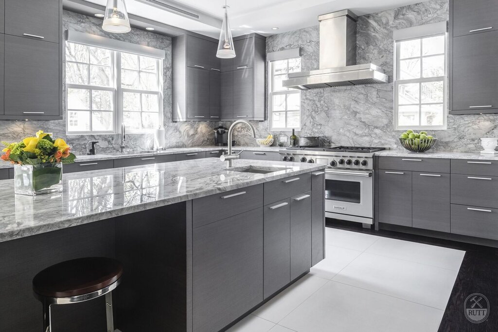 White and gray kitchen with a marble countertop