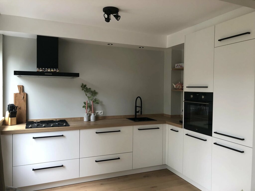 Beige kitchen with black handles