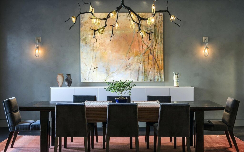 A wall lamp above the dining table