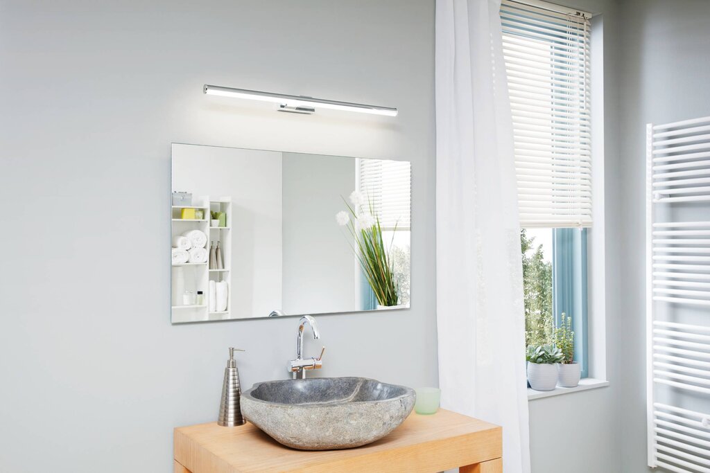 A sconce above the mirror in the bathroom