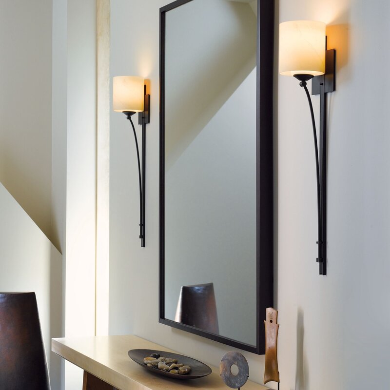 The sconce near the mirror in the hallway