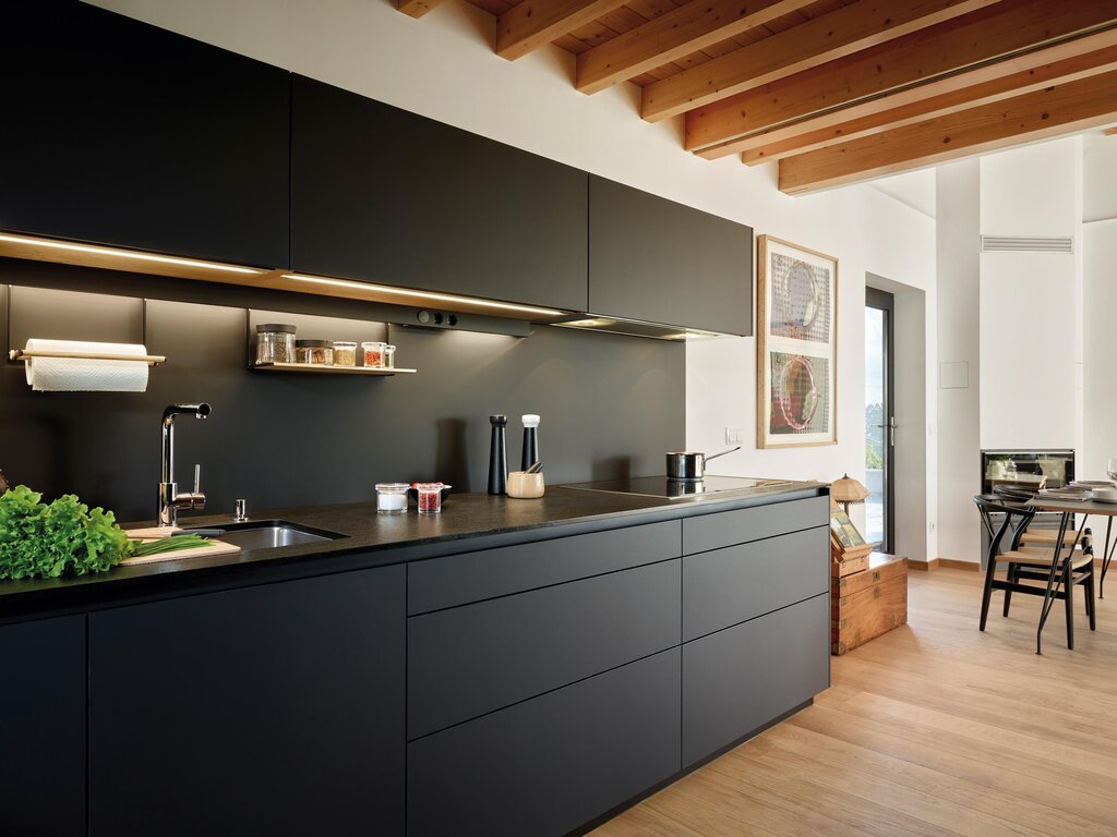 Black matte kitchen with a wooden countertop