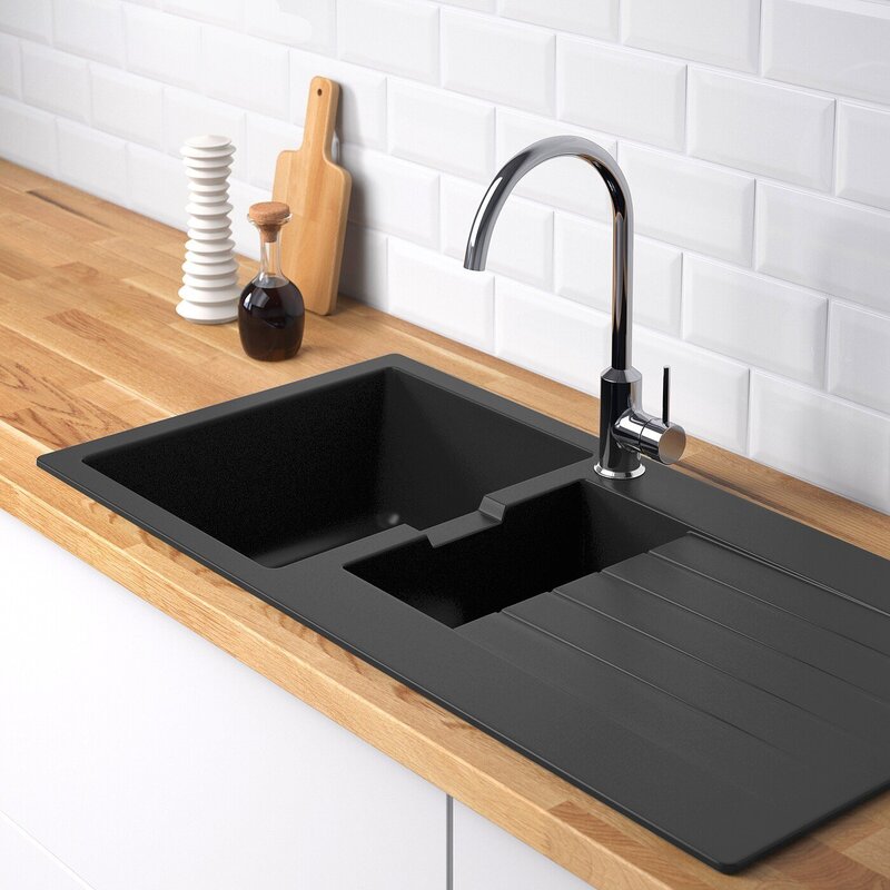 Black sink on a white countertop