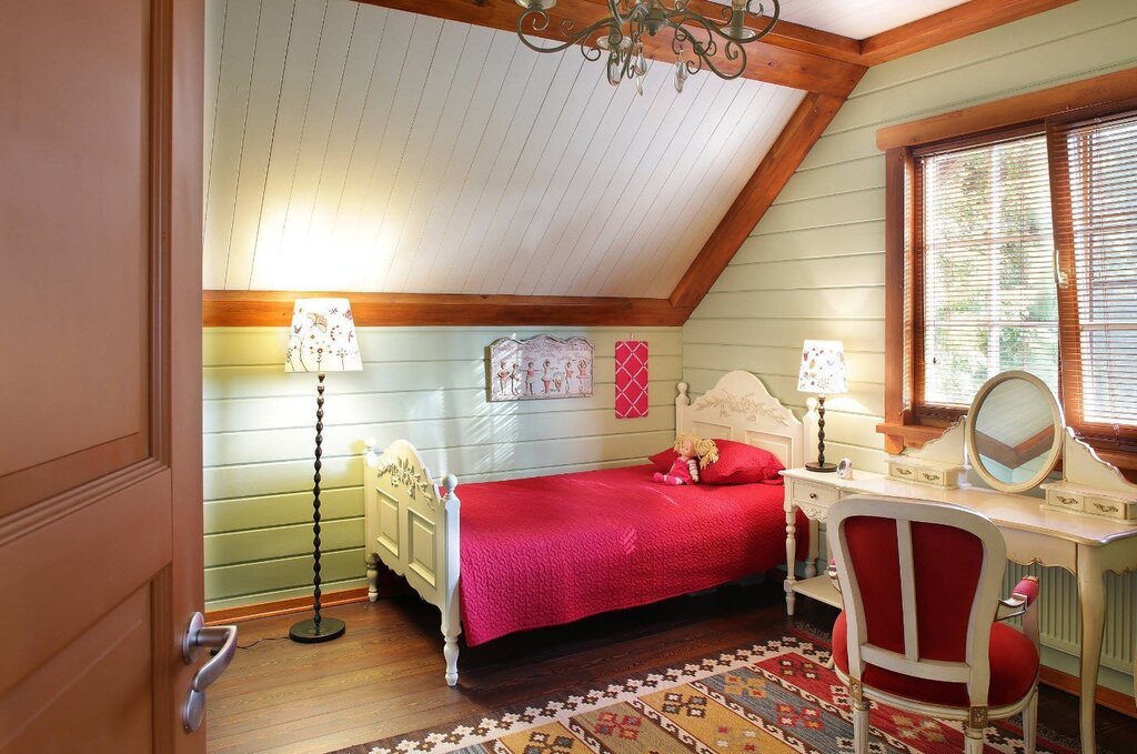 Children's room in the attic of a wooden house