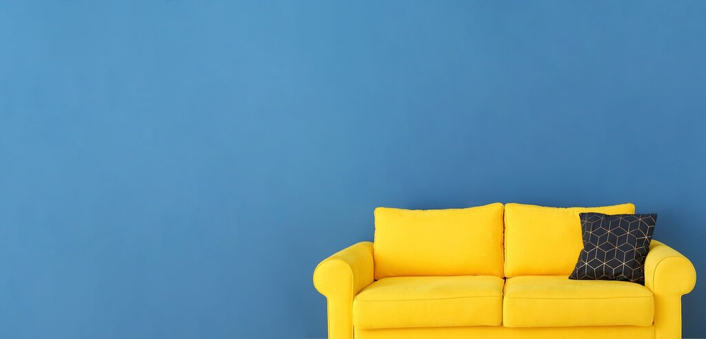 A sofa against a white wall