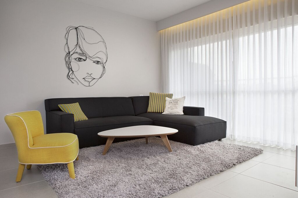 Living room design with a yellow sofa