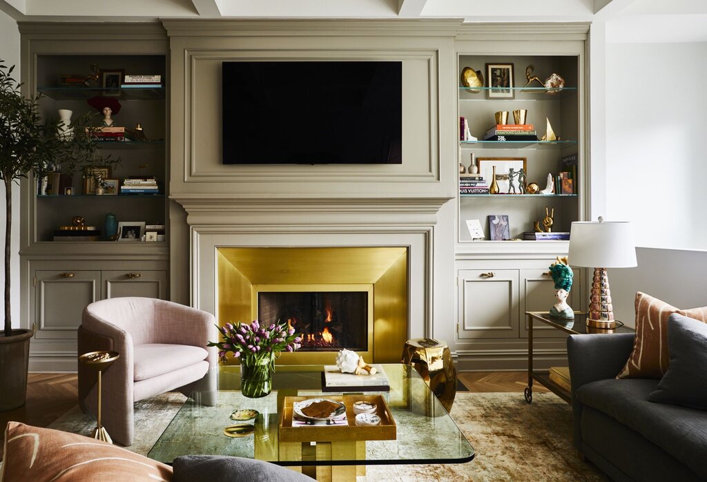 Room design with a fireplace and a TV 46 фото