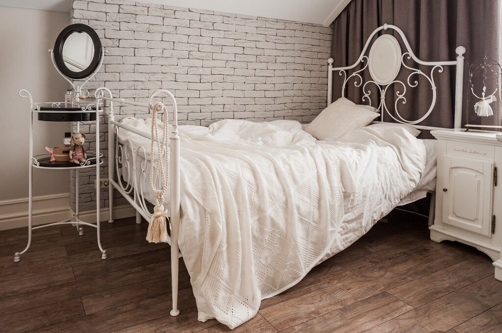 Bedroom design with a wrought iron bed