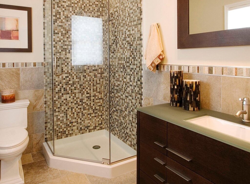 A tiled shower in a small bathroom