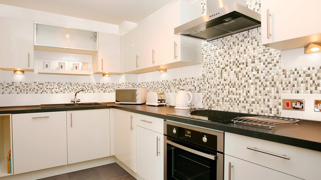 A backsplash for a white kitchen made of tiles