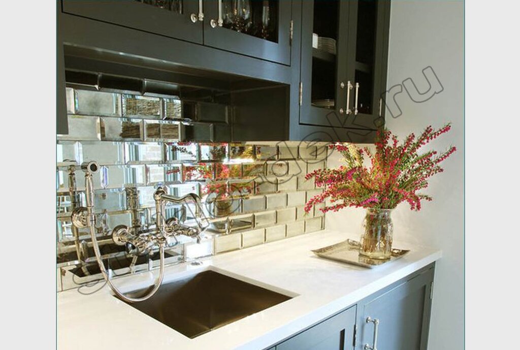 A kitchen backsplash made of mirror tiles