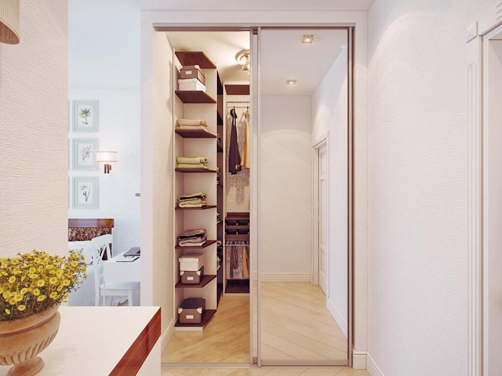 A walk-in closet in a narrow hallway