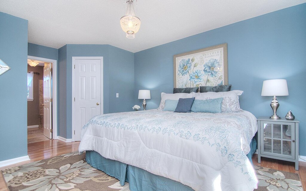 Blue bedroom with white furniture