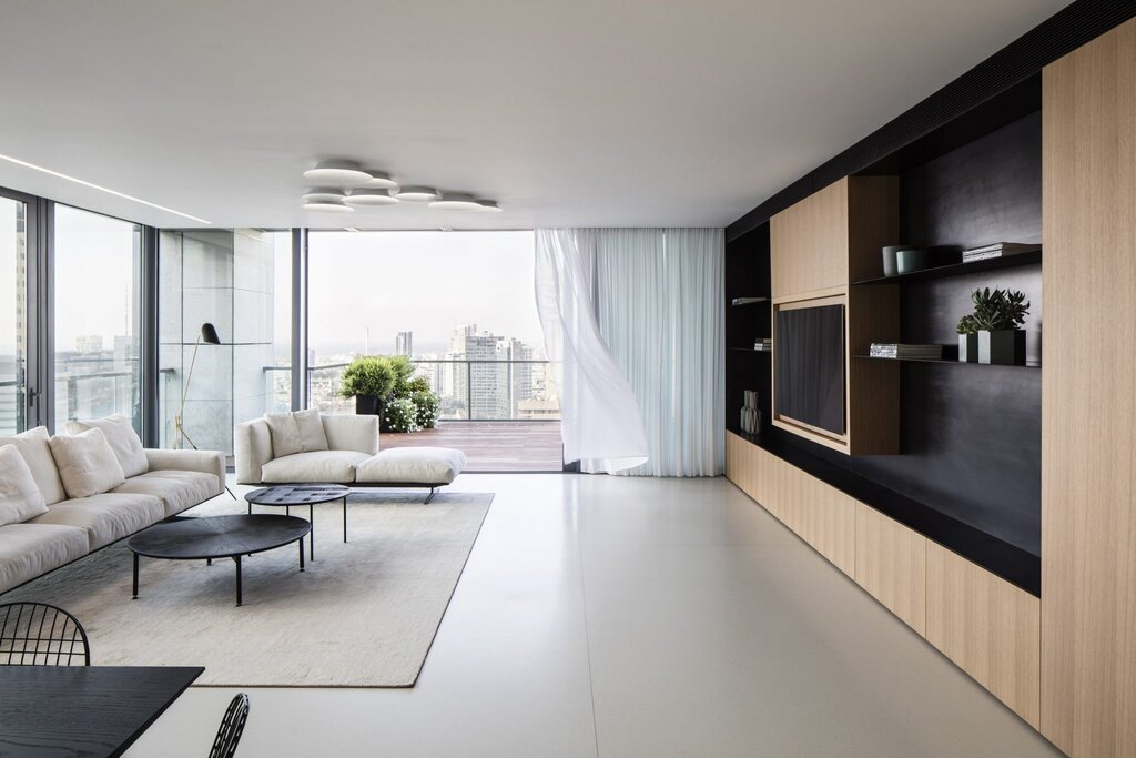 A living room with panoramic windows in the apartment