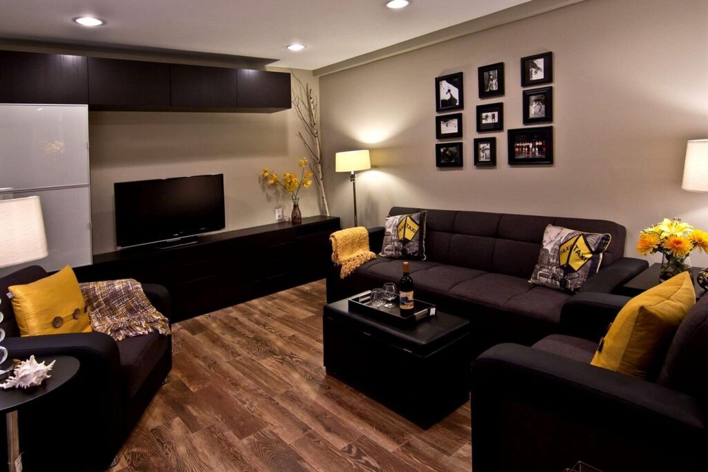 The interior of the living room with dark furniture