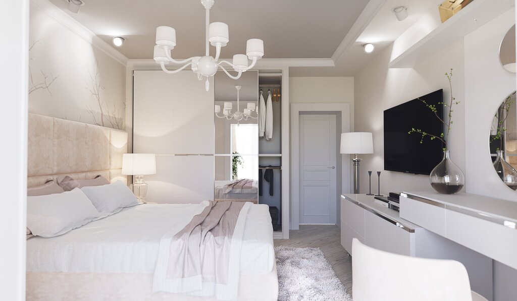 The interior of a small bedroom in light tones