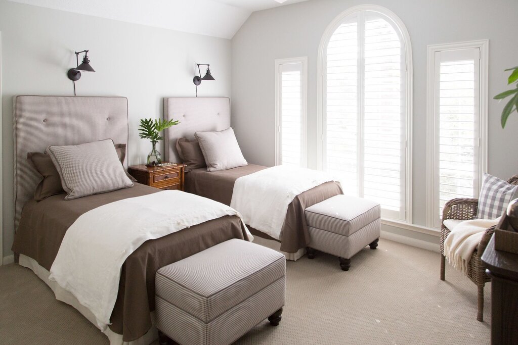 The interior of a bedroom with two beds