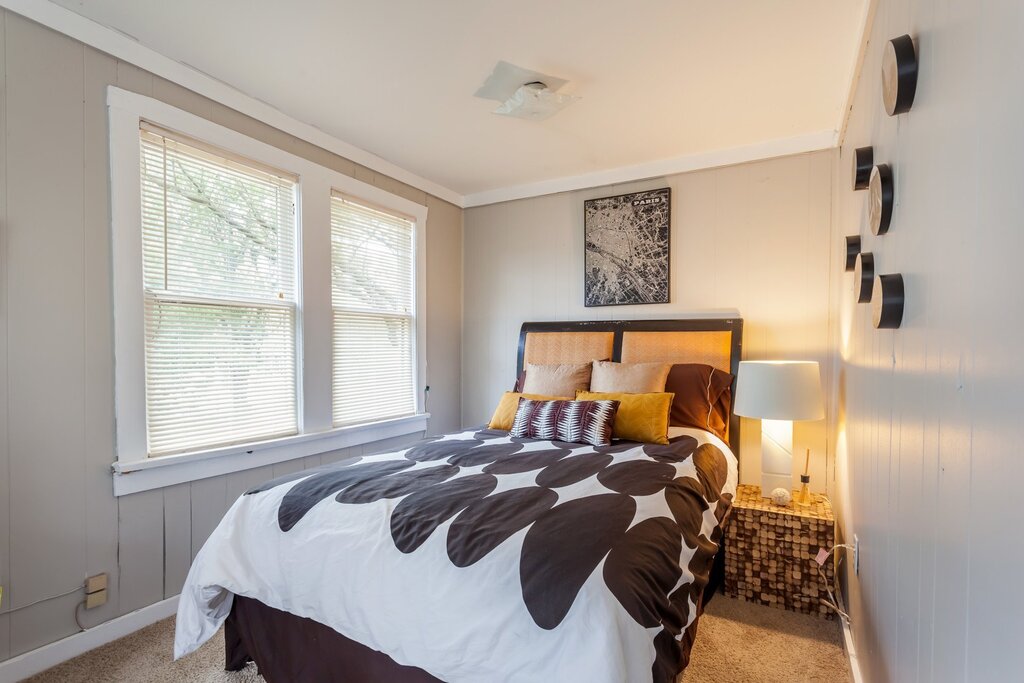 The interior of a narrow bedroom with one window