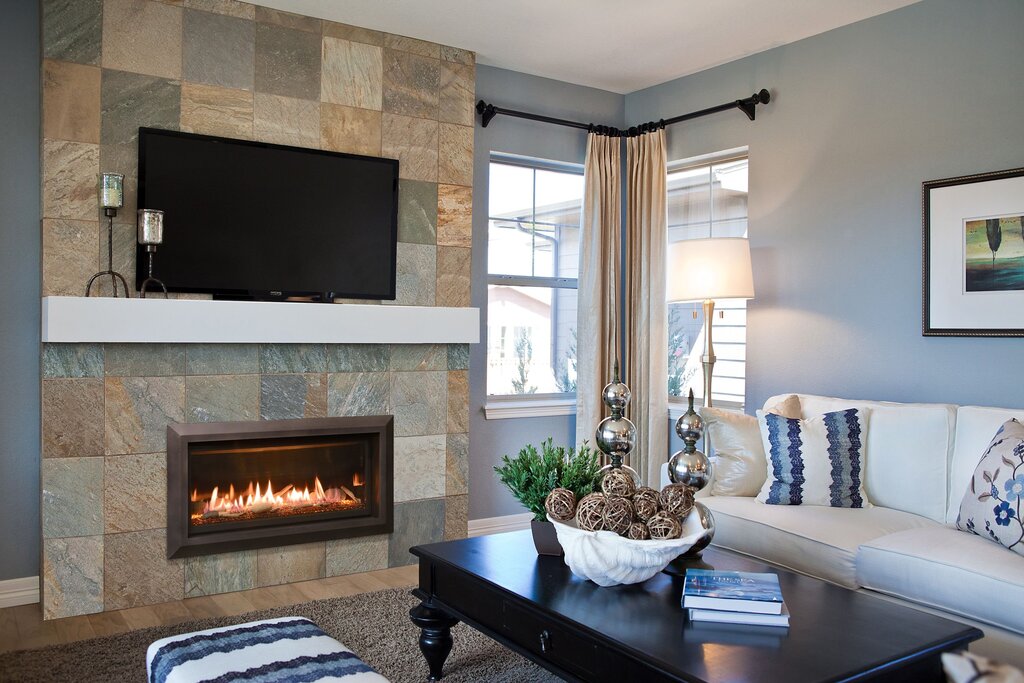 A fireplace with a television in the interior