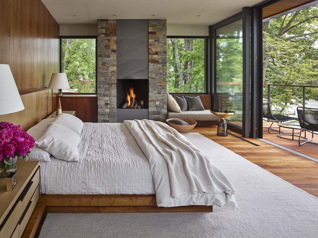 A fireplace by the window in the interior