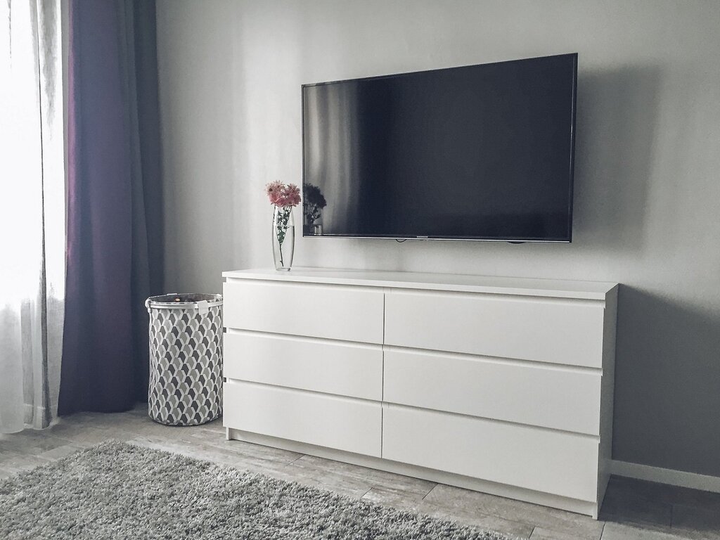 A dresser for a TV in the bedroom