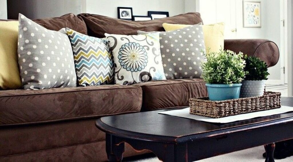 Brown sofa with cushions in the interior