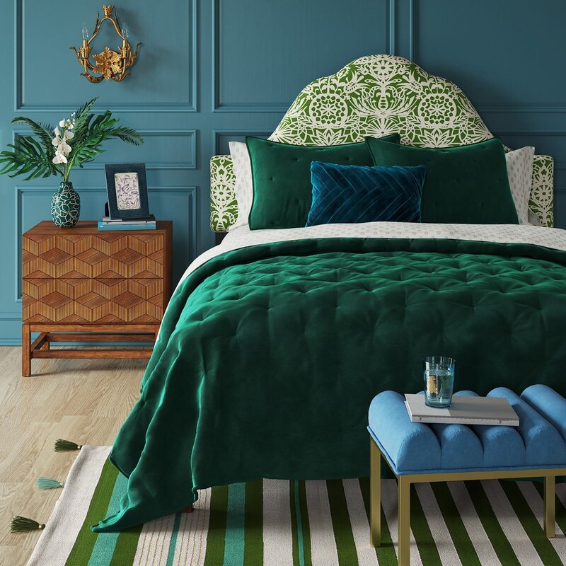 An emerald-colored bed in the interior