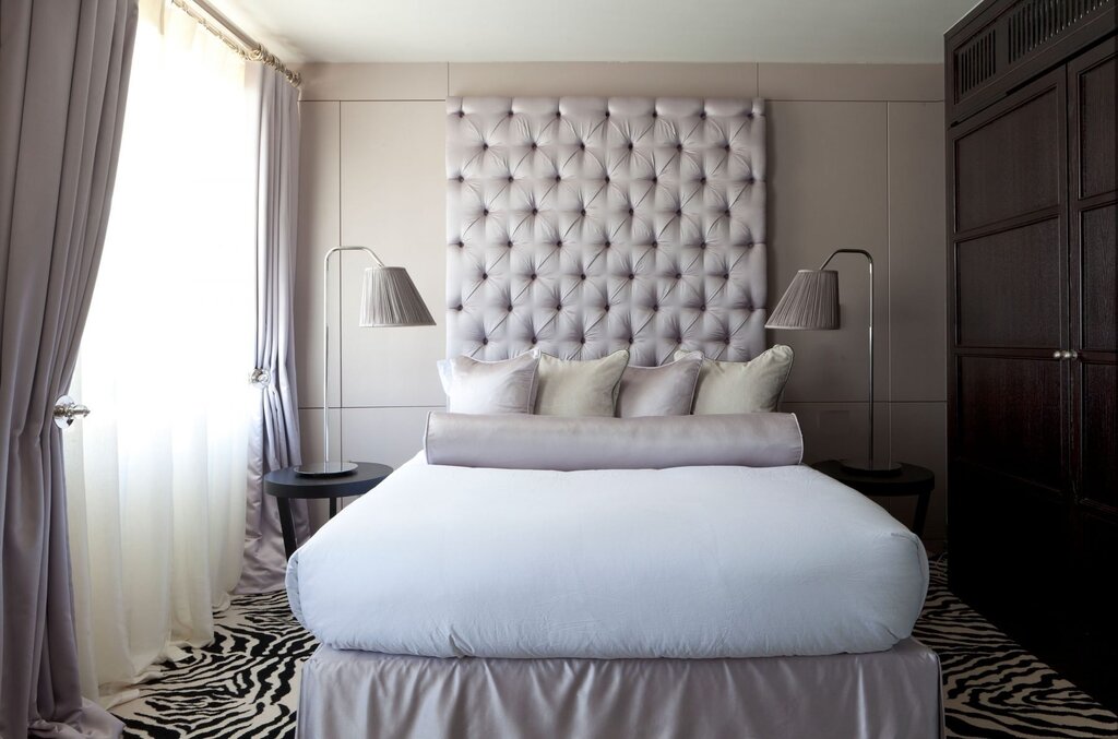 A bed with tufted upholstery in the interior