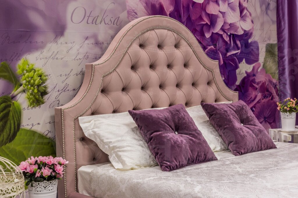 A bed with tufted upholstery