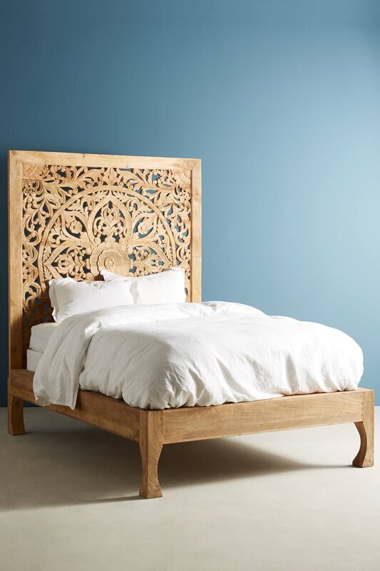 Bed with a carved headboard