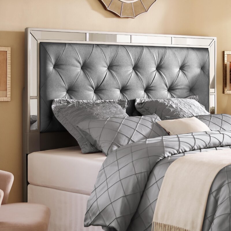 Bed with a mirrored headboard