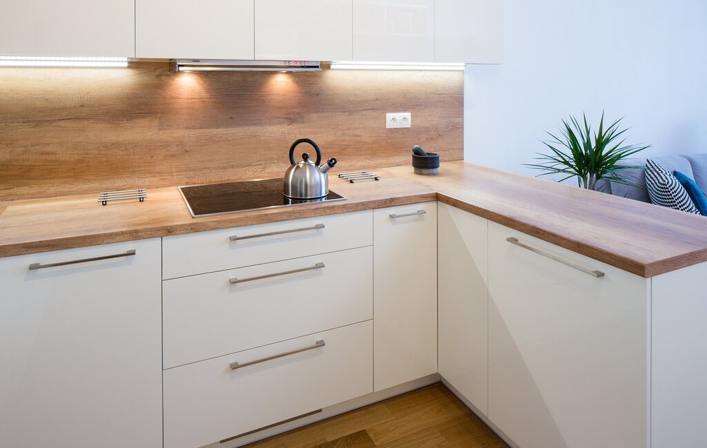 White gloss kitchen with a wooden countertop