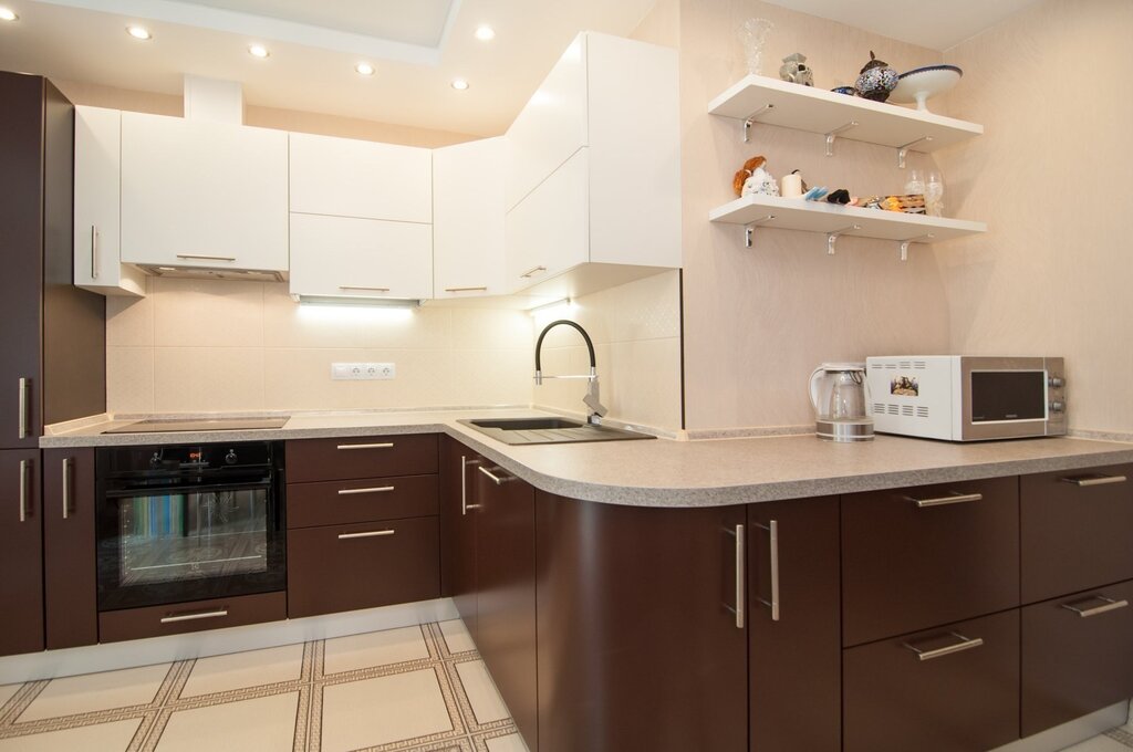 The kitchen has beige upper cabinets and brown lower cabinets