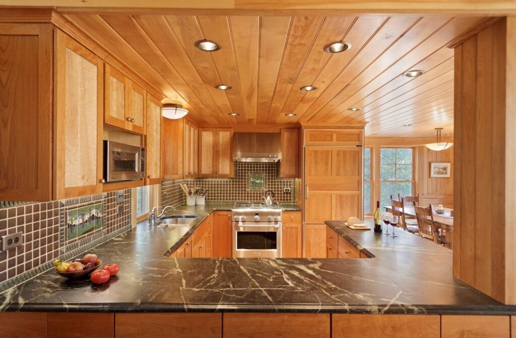 The kitchen is paneled with clapboard