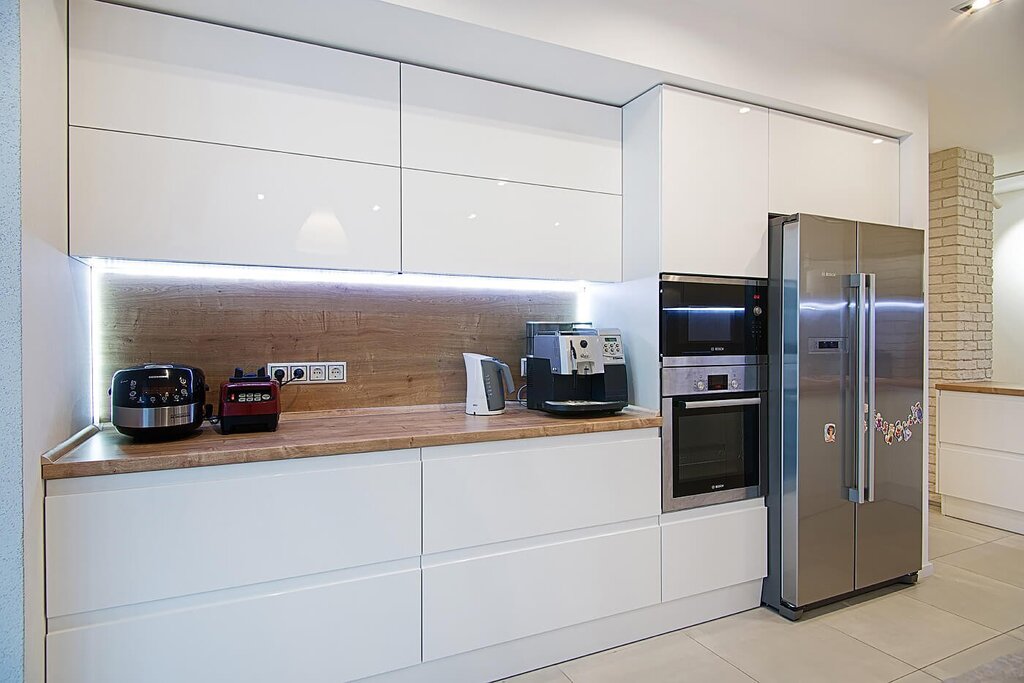 A kitchen with a large refrigerator