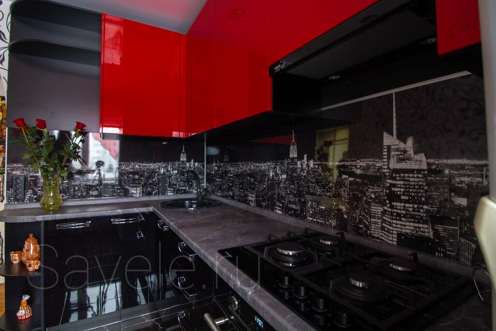 A kitchen with a black countertop and backsplash