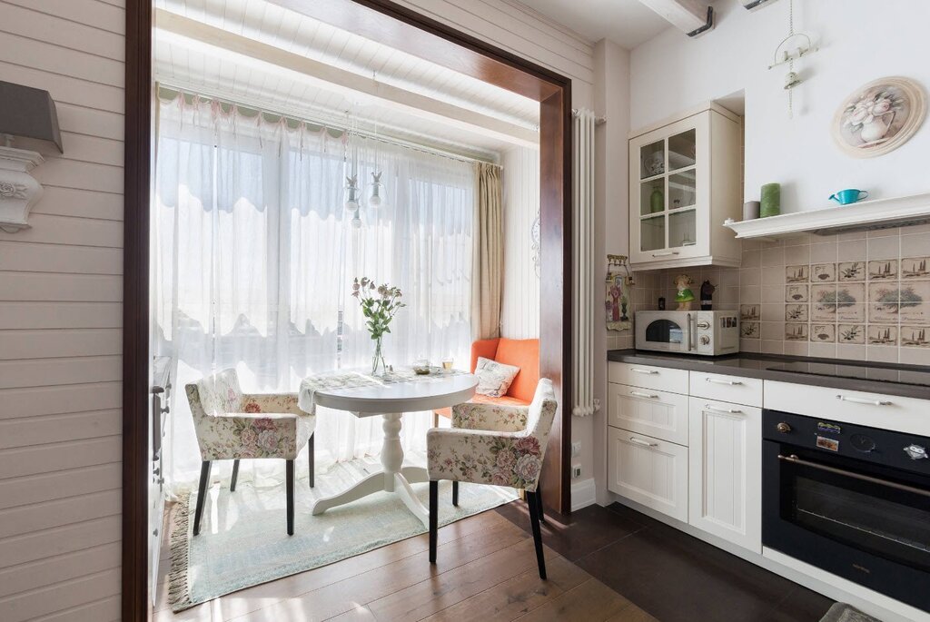 A kitchen with a door to the balcony