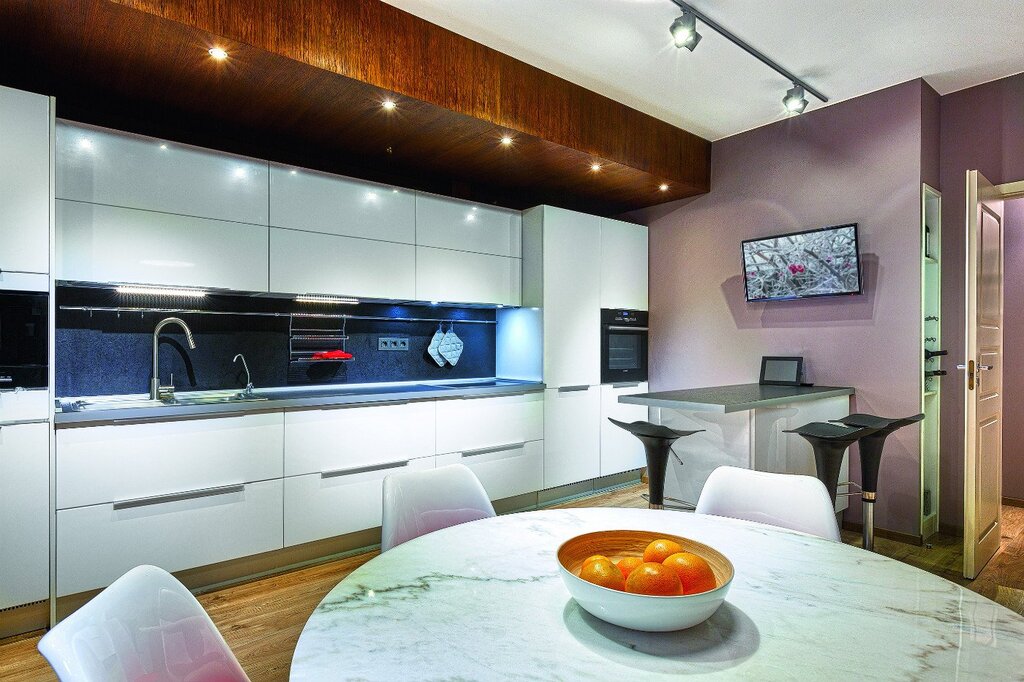 A kitchen with a false panel up to the ceiling