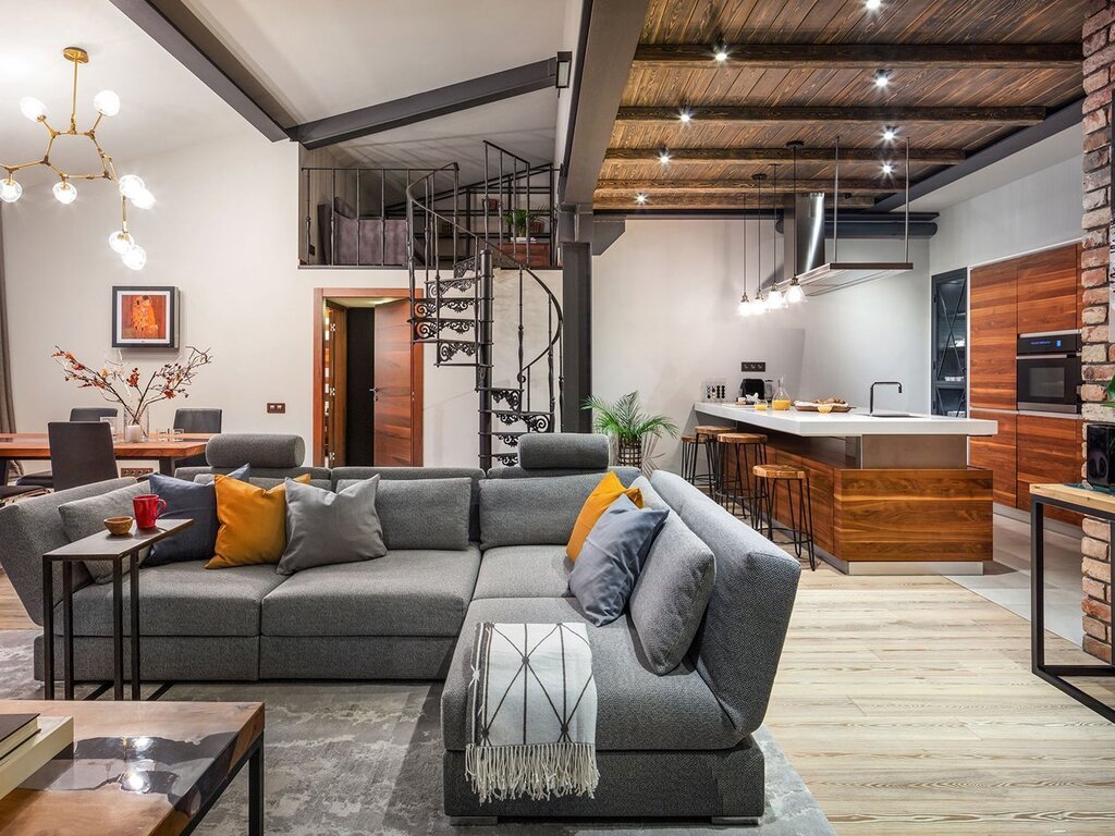 A kitchen with a living room in a loft style