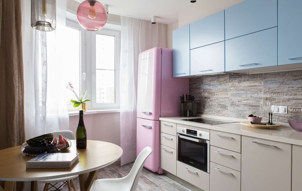 A kitchen with a refrigerator by the window