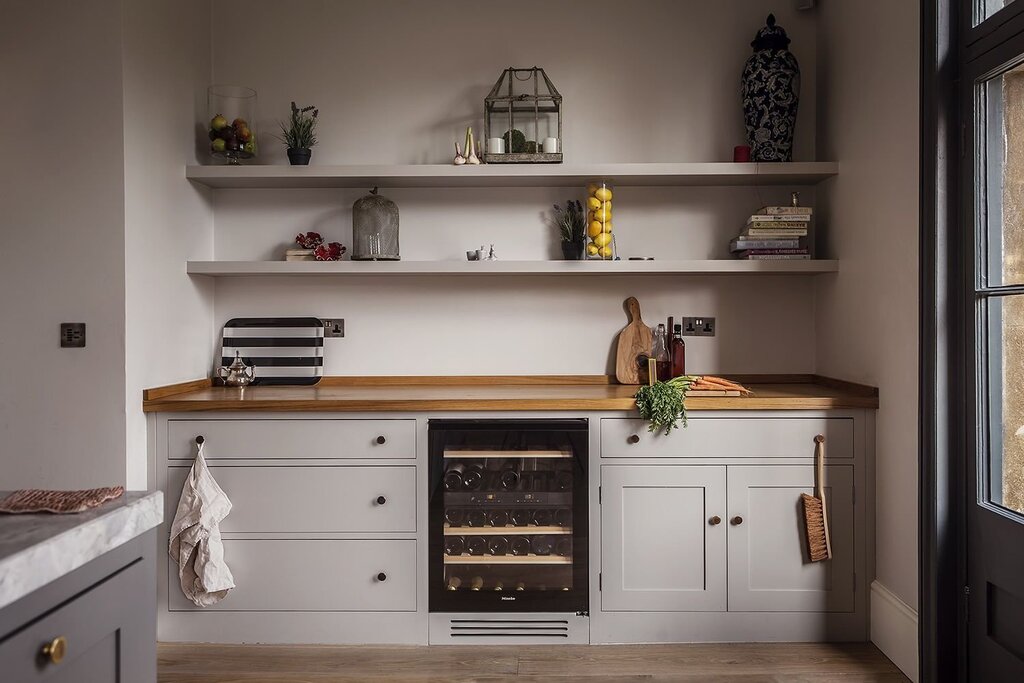 A kitchen with open shelves and cabinets