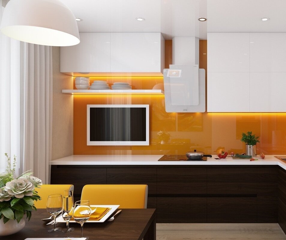 A kitchen with a TV on the wall