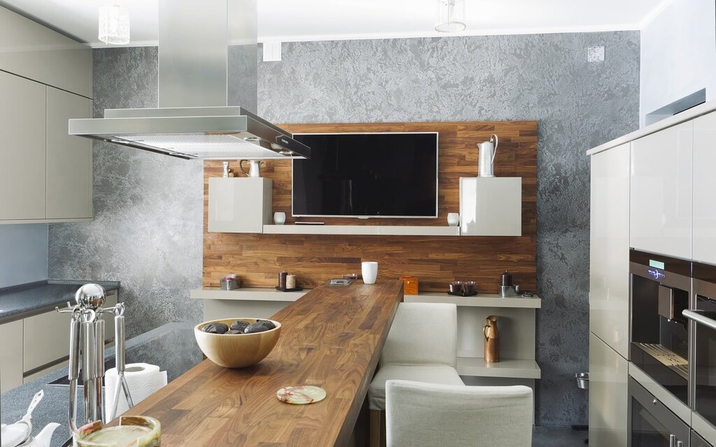 A kitchen with a television in the kitchen set