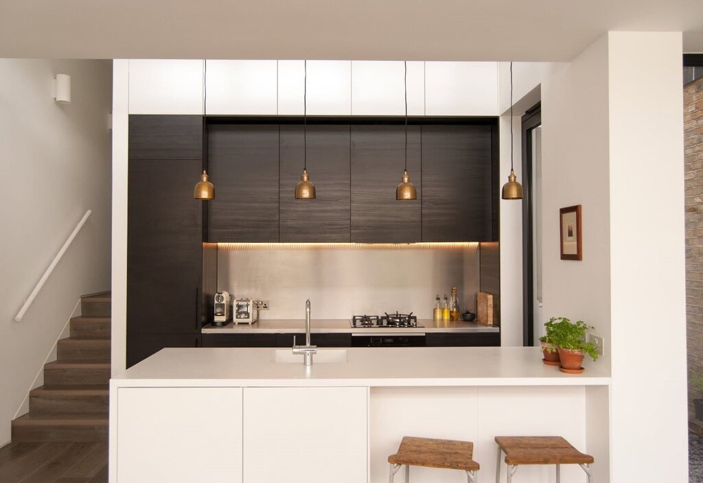 A kitchen with a recessed wall