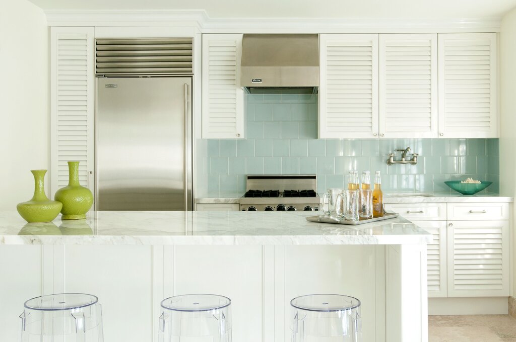 A kitchen with louvered fronts