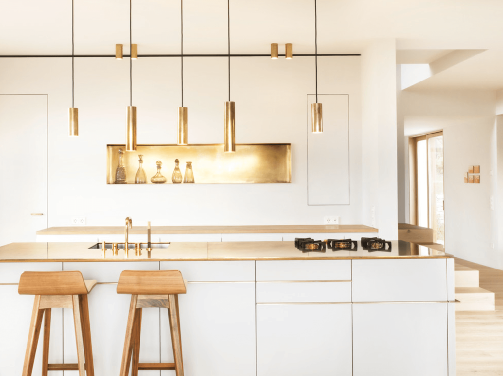 A kitchen with gold elements